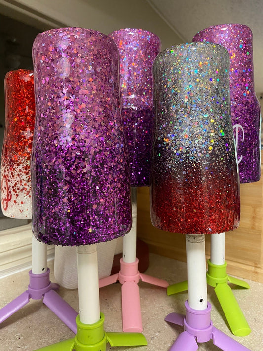A collection of sparkling custom glitter tumblers in various colors, featuring ombré designs, personalized text, and a glossy finish. Perfect for adding a touch of sparkle to your day.